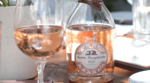a bottle of Santa Margherita rose next to a glass of wine