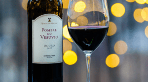 a bottle of quinta do vesuvio pombal do vesuvio douro wine next to a glass of red wine